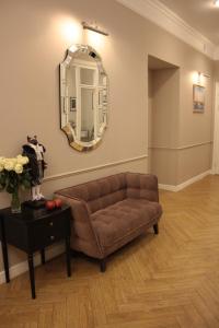 a living room with a couch and a mirror at Grand Memories in Saint Petersburg