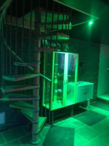 a bathroom with a sink and a spiral staircase at Linfinity in Baillonville +8 photos