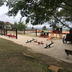 a park with a playground with a swing set and a playground at Flat na Fazenda Monte Castelo Gravatá in Gravatá