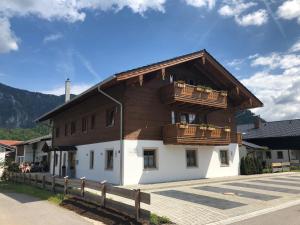 a large wooden building with two balconies on it at Haus im Moos - Chiemgau Karte in Inzell