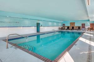 a large indoor swimming pool with blue water at Comfort Suites West Memphis I-40 I-55 in West Memphis