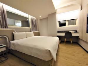 Postelja oz. postelje v sobi nastanitve Hub Hotel Ximen Inn