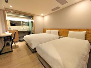 Postelja oz. postelje v sobi nastanitve Hub Hotel Ximen Inn