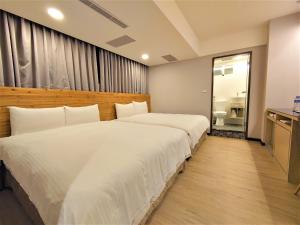 Postelja oz. postelje v sobi nastanitve Hub Hotel Ximen Inn