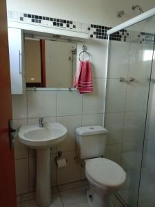 a bathroom with a toilet and a sink and a mirror at Hotel ZM Premium in Cosmópolis +33 photos