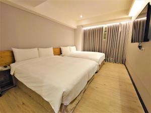 Postelja oz. postelje v sobi nastanitve Hub Hotel Ximen Inn