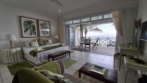 a bedroom with a bed and a view of the ocean at Shaka's Seat Guesthouse - Check Out Our May Special! in Ballito