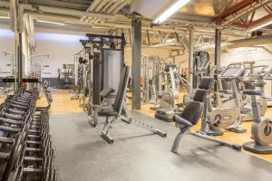 a gym with lots of treadmills and machines at Hotell Moskogen in Leksand