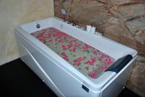 a white bath tub sitting next to a white wall at Cottage San Francesco in Nuwara Eliya