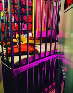 a cage with a bed in a room at Secret Room votre chambre coquine et insolite en espace privatif a Tournai in Tournai