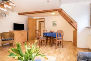 a dining room with a blue table and chairs at Ferienwohnung Nr 2 in Deggenhausertal