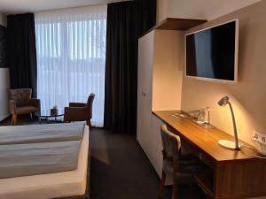 Postel nebo postele na pokoji v ubytování Hotel Starton am Ingolstadt Village