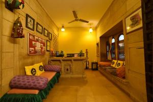 a living room with couches and a fireplace at The Hosteller Jaisalmer in Jaisalmer