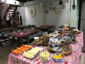 a table with food on it in a restaurant at Acapela Hospedagem in Ouro Preto +32 photos