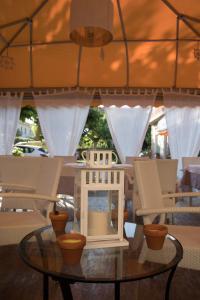 a table with chairs and a house on top of it at Hotel Giulia in Marina di Massa