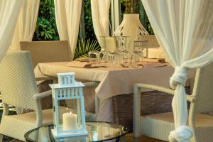 a dining table with a candle on top of it at Hotel Giulia in Marina di Massa