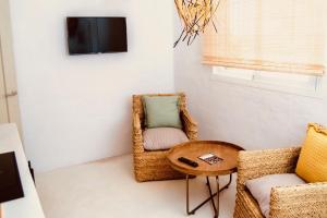 a living room with two chairs and a table at Can Petit - Romantic & Cozy Villa in Sant Ferran de Ses Roques +15 photos