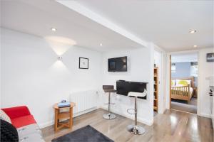 a living room with a couch and a desk at The Hidden Gem in Kegworth