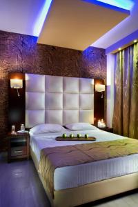 a bedroom with a large bed with a large headboard at 4- you Family in Metamorfosi
