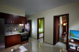 a kitchen with wooden cabinets and a tv in it at 4- you Family in Metamorfosi