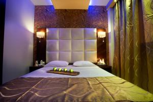 a bedroom with a large bed with candles on it at 4- you Family in Metamorfosi
