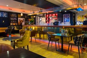 a restaurant with tables and chairs and a bar at Hotel Café Restaurant De Posthoorn in Dokkum
