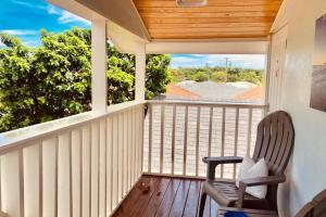 a rocking chair on a porch with a view at King & Queen Suite #8 in Nassau