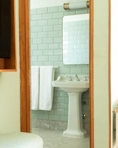 a bathroom with a sink and a mirror and towels at Hotel Boutique Casa Recreo in Viña del Mar