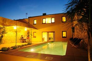 a house with a swimming pool in front of it at Ca l'Helena in Castellet