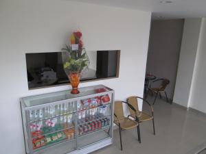 a drink cooler with a vase on top of it at Guest House Remaja in Samarinda