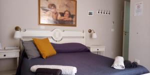 a bedroom with a bed and a painting on the wall at Il Sole del Mediterraneo in Noto