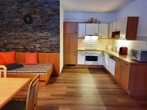 a kitchen with a couch and a table in a room at ANDREA in Fügen