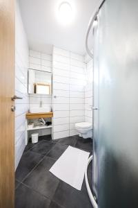 a bathroom with a toilet and a sink at 1oak rentals 2 in Vir