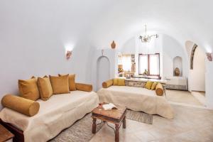 a living room with a couch and a table at Kokos Traditional Houses in Emporio Santorini