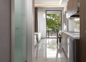 a kitchen with a counter and a table and a window at 4- you Family in Metamorfosi