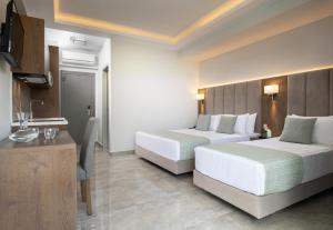a hotel room with two beds and a kitchen at 4- you Family in Metamorfosi