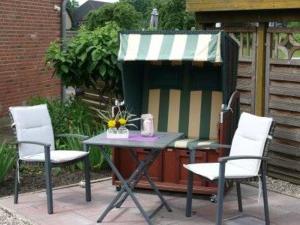a table with two chairs and a table with a canopy at Haus Rose in Nortorf