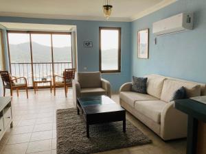 a living room with a couch and a table at Kadyanda Apartments in Fethiye