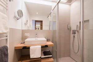 a bathroom with a sink and a shower at Hotel Apart Piz Mundin in Kappl