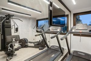 a gym with treadmills and ellipticals at Appart'City Collection Genève Aéroport - Ferney Voltaire in Ferney-Voltaire