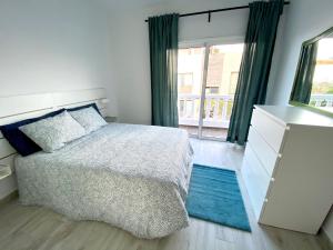 a bedroom with a bed and a large window at Apartamento MEDAL in El Cotillo