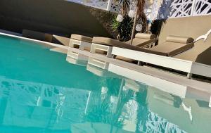 a swimming pool with lounge chairs and the water at Europa Hotel in Rhodes Town