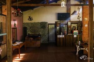 a room with a table and a tv in a room at Pousada e Restaurante Victórios in Caeté