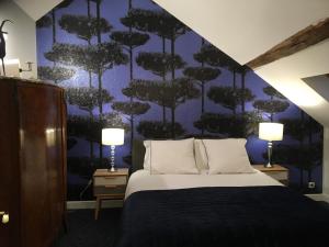 Säng eller sängar i ett rum på La Maison D'Hôtes Nantes Centre
