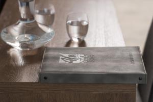 a box on a wooden table with two wine glasses at 4- you Family in Metamorfosi