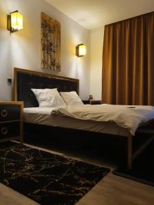 a bedroom with a large bed with white sheets at Silver Mountain Luna CD05 in Poiana Brasov