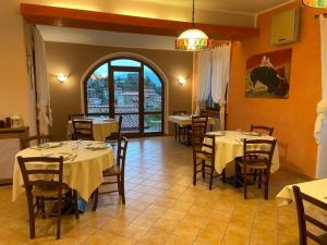 a restaurant with tables and chairs in a room at Hotel Ristorante El Caracol in Mulazzo