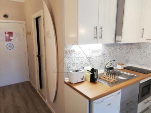 a kitchen with a sink and a toaster on a counter at The Surf Studio - Ericeira in Ericeira