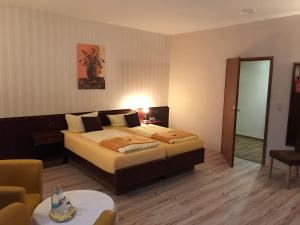 ein Hotelzimmer mit einem Bett und einem Tisch in der Unterkunft Hotel Schöne Aussicht in Weißenfels