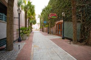 an empty alley with palm trees and a building at 243 Rutledge in Charleston